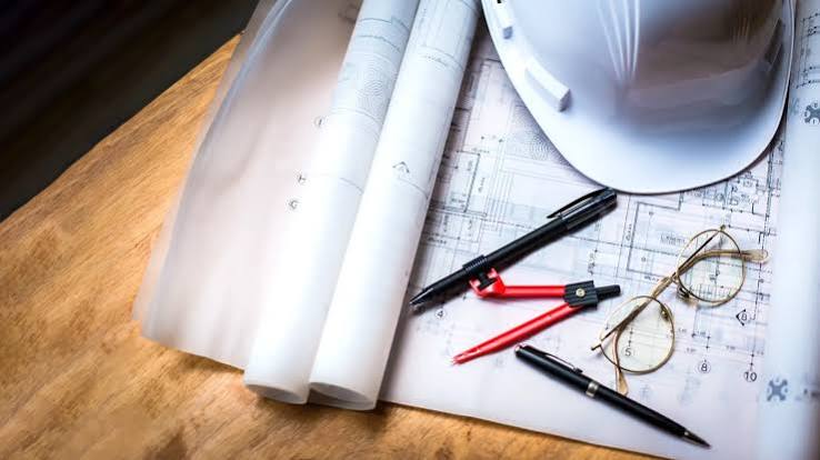 Blueprints, hard hat and drawing tools