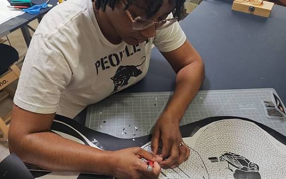 Designer working on plans at a desk