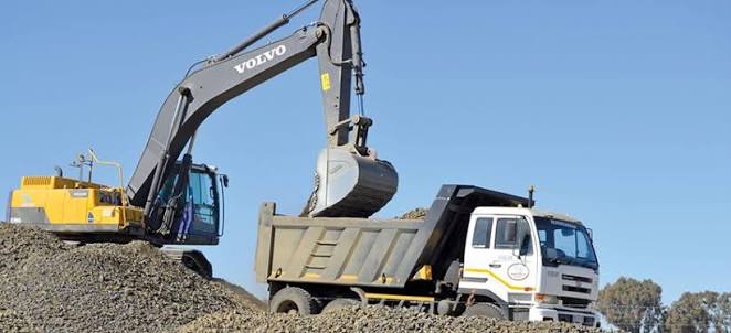 Excavator loading a dump truck