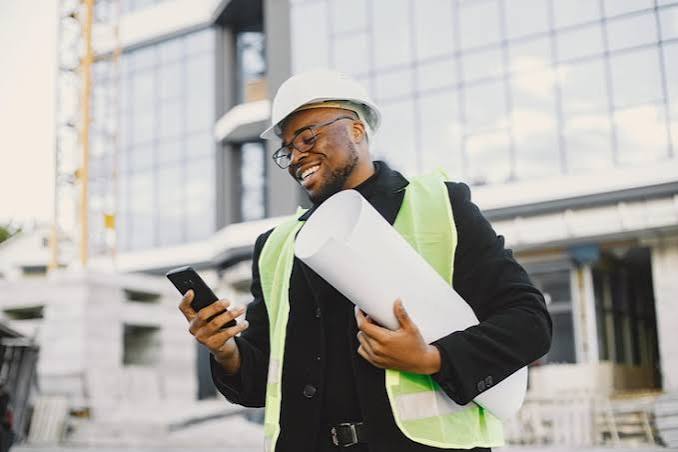 Project manager with plans and phone