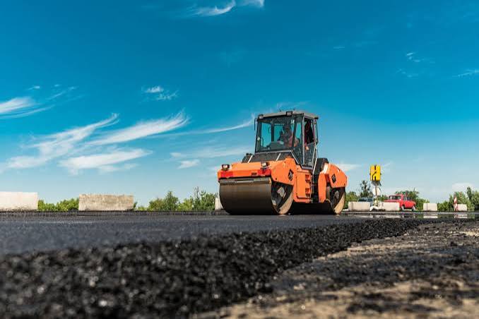Road roller compacting fresh asphalt