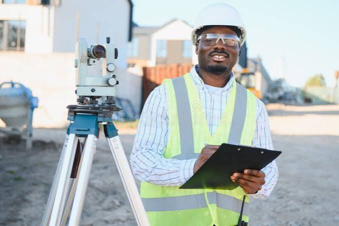 Surveyor with clipboard and theodolite