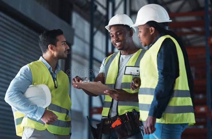Site team discussing work in hard hats